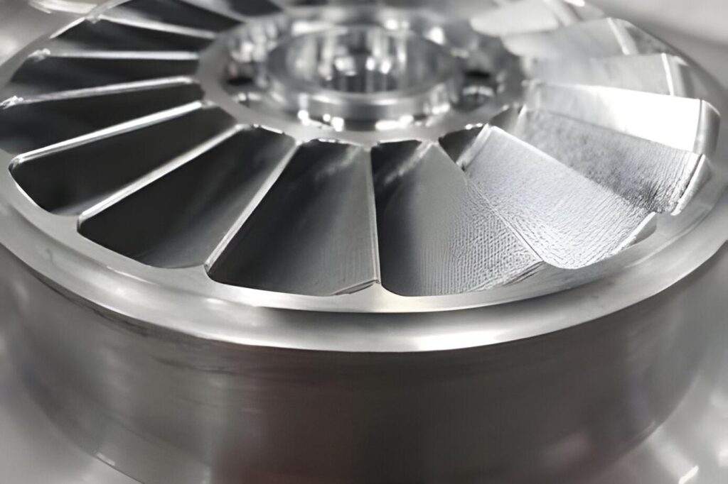 A close up macro photograph of a metallic turbine wheel with precise engineering details