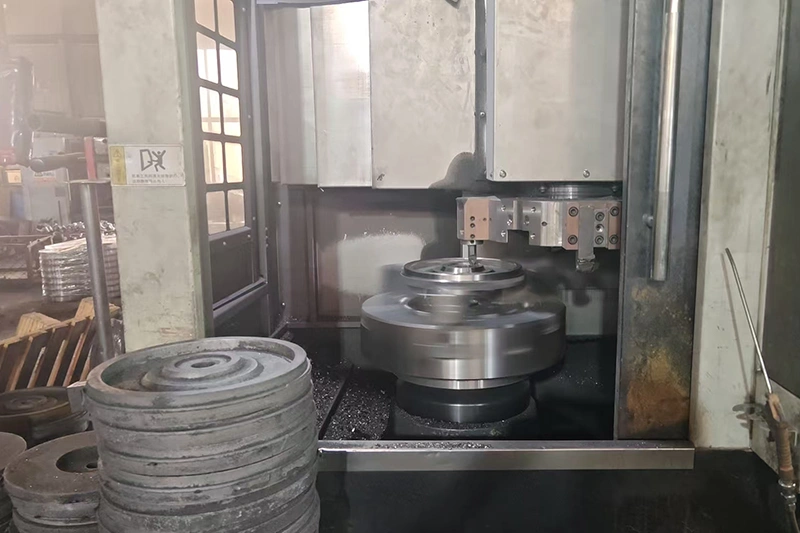 Kurt Foundry CNC machining a custom industrial flywheel — single-source manufacturing from casting to finished component.