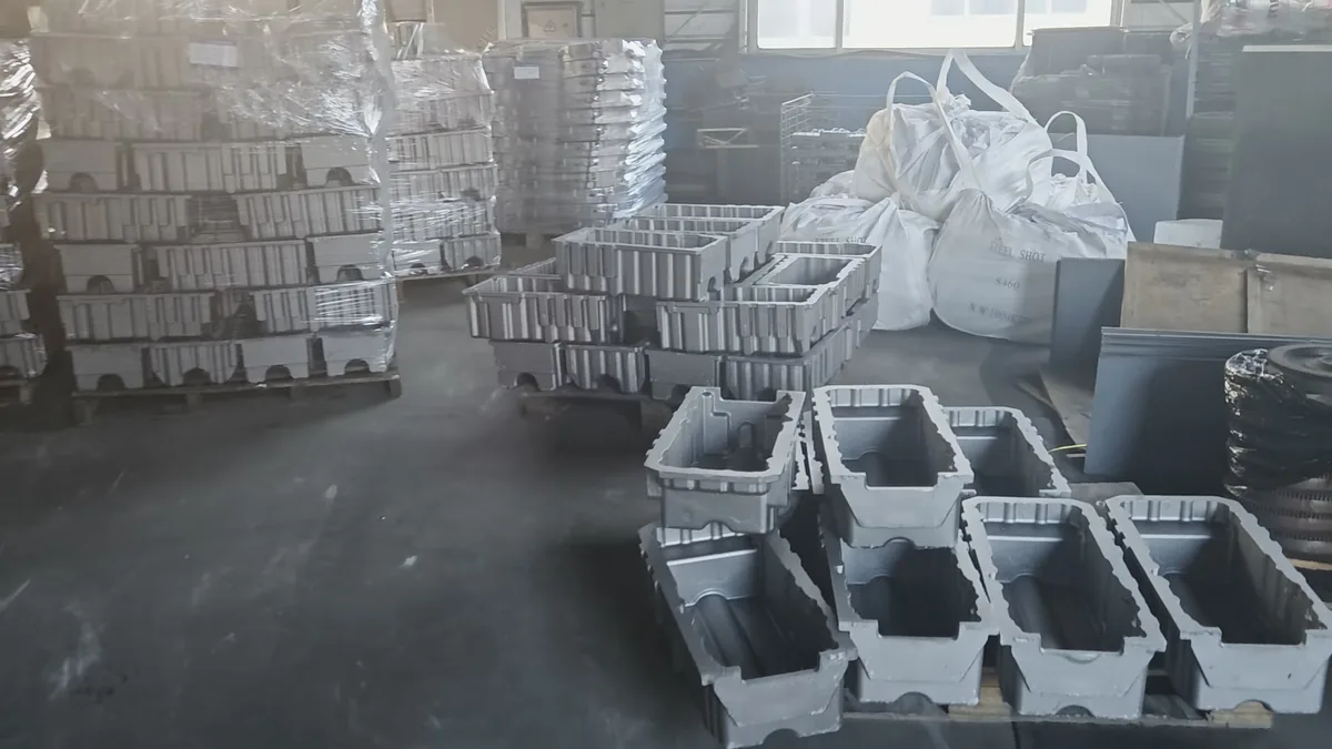 Large grey iron box-section housings in the Kurt Foundry warehouse